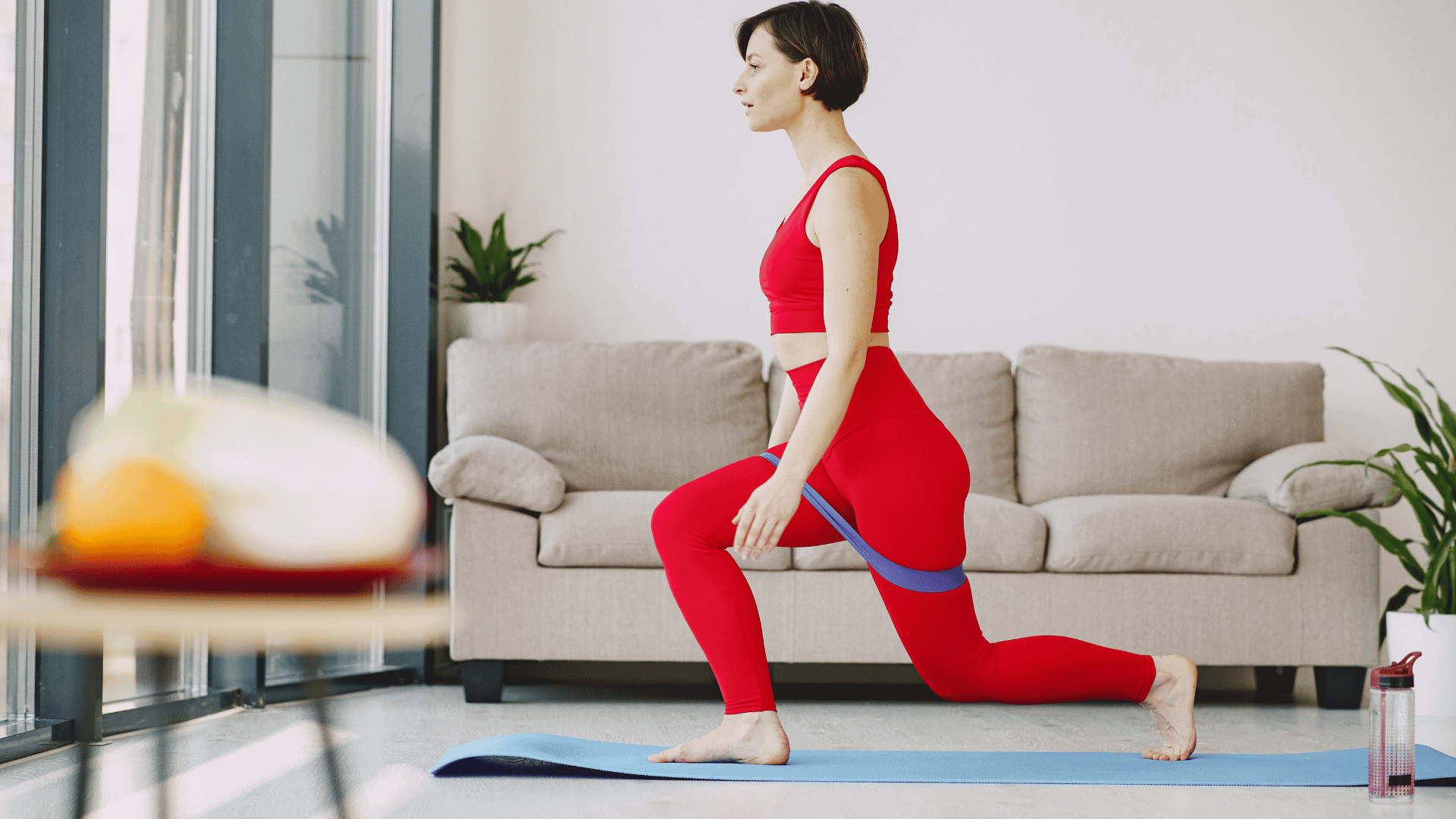 Woman performing walking lunges with a resistance band at home, 10 reps per leg.