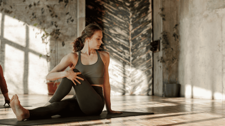 A woman doing stretching her body while lying on the floor