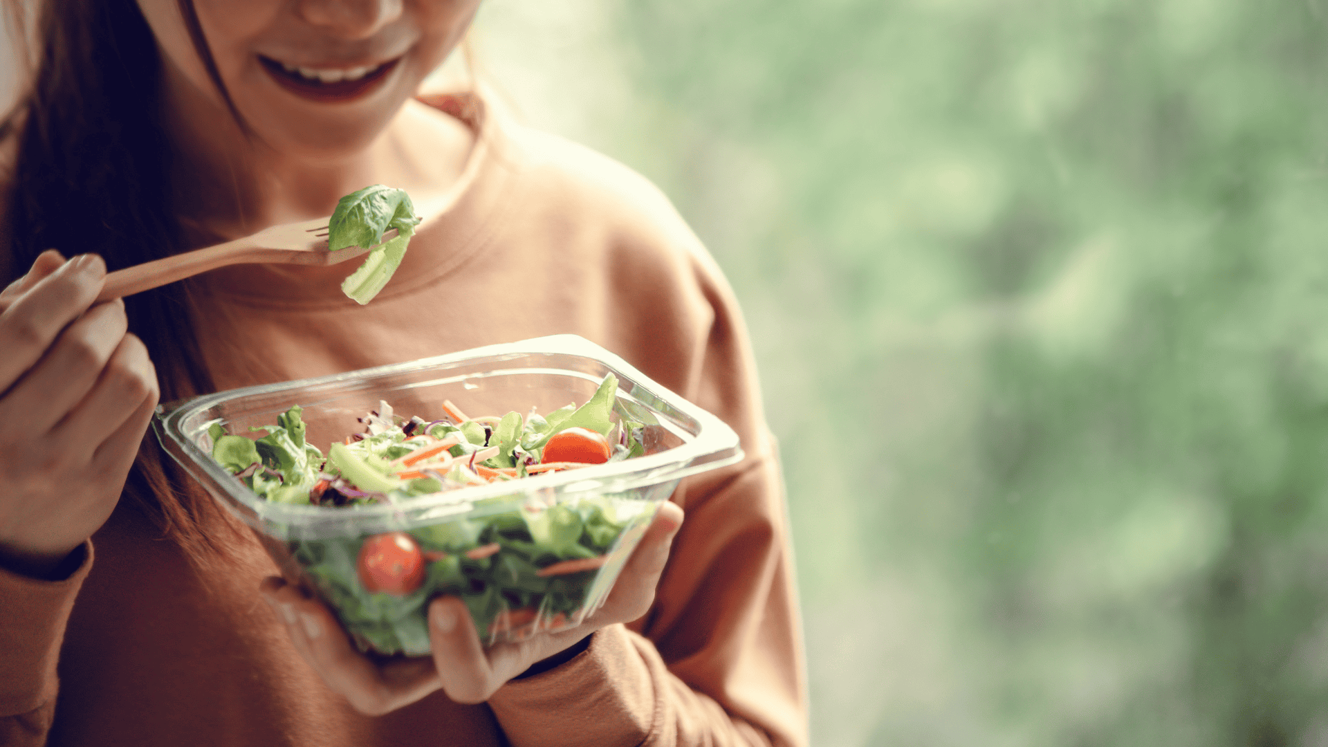 A woman eating healthy food salad