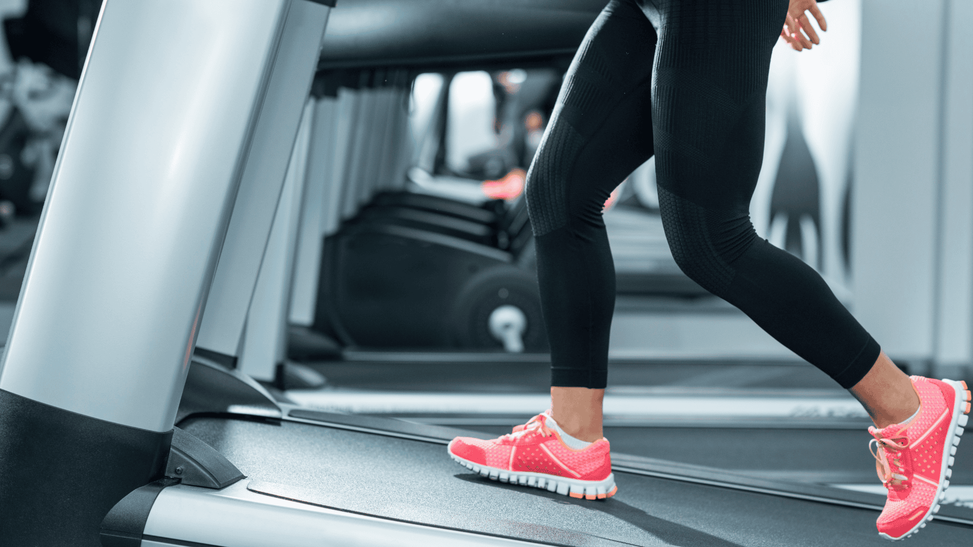 A woman walking on an incline treadmill A woman walking on an incline treadmill