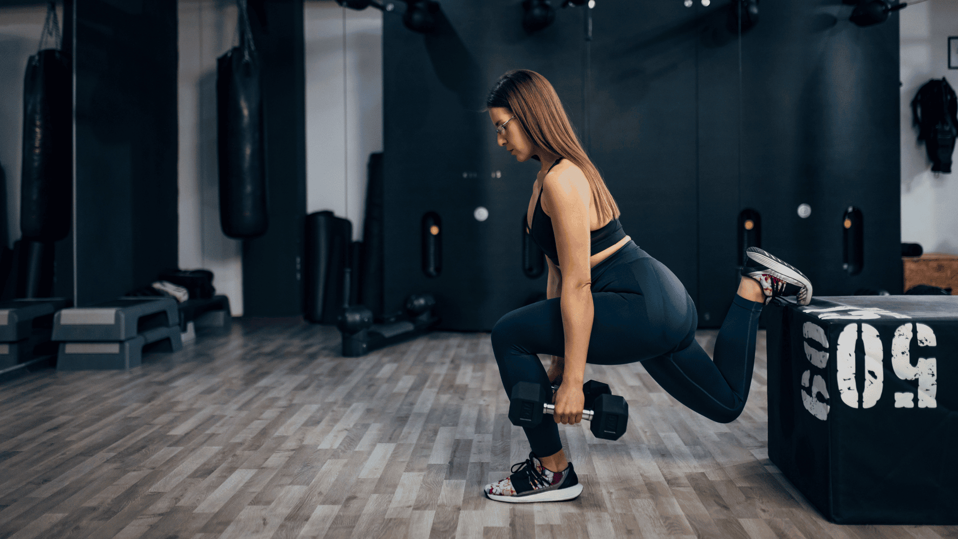 woman who leads an active lifestyle trains in the gym doing the Bulgarian squat