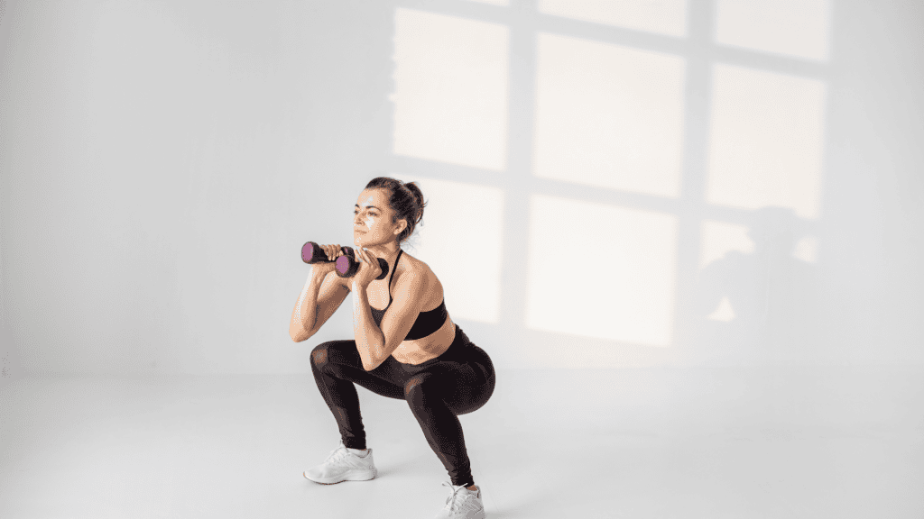 Fit Woman Using Dumbbells to Workout