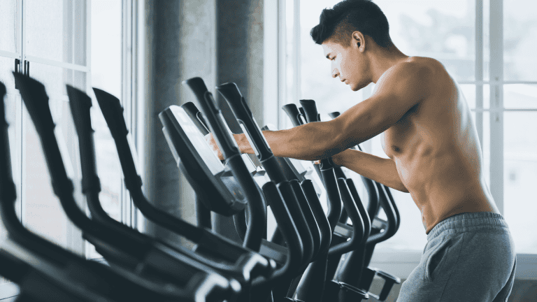 Man doing cardio on an exercise machine at the gym.