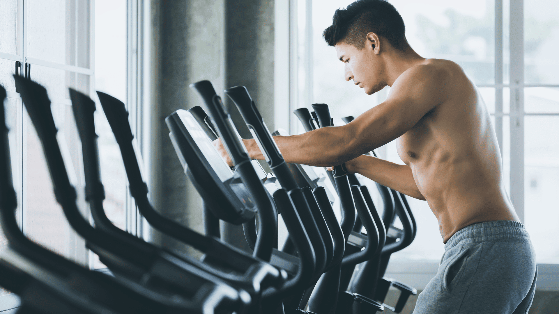 Man doing cardio on an exercise machine at the gym.