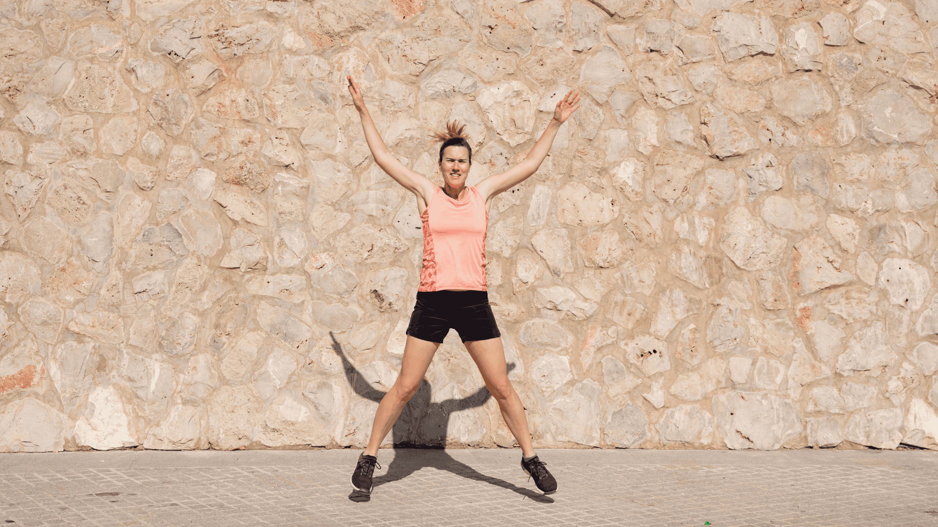 Mature Woman Doing Jumping Jacks Outdoors