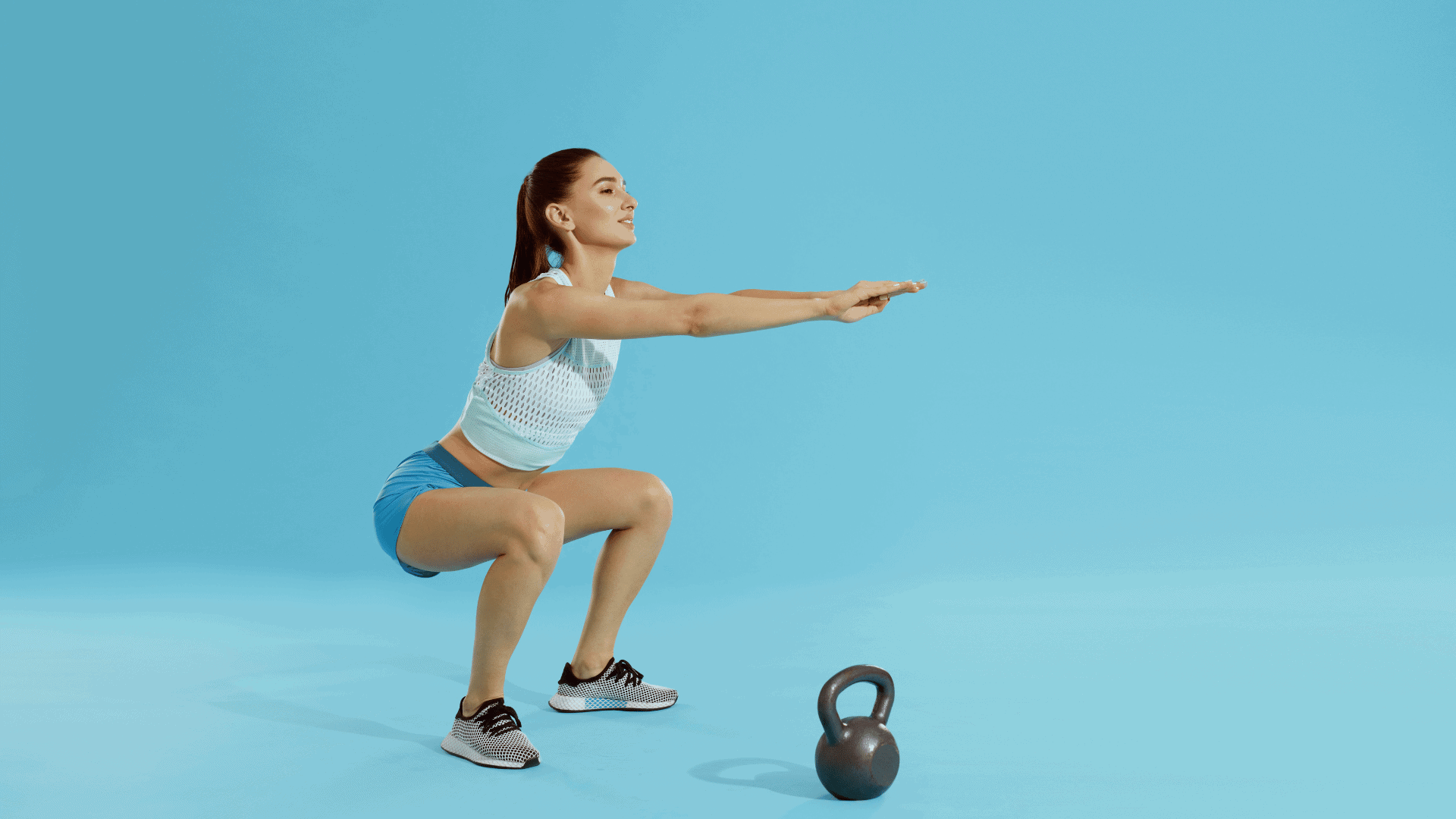 Squats. Fitness woman in sports wear exercising, doing squat