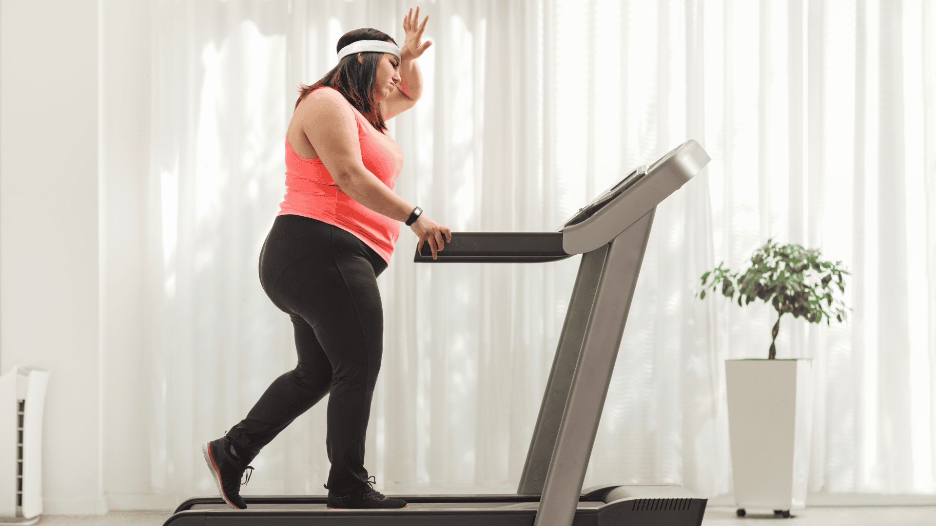 Tired woman exercising on a treadmill at home Tired woman exercising on a treadmill at home