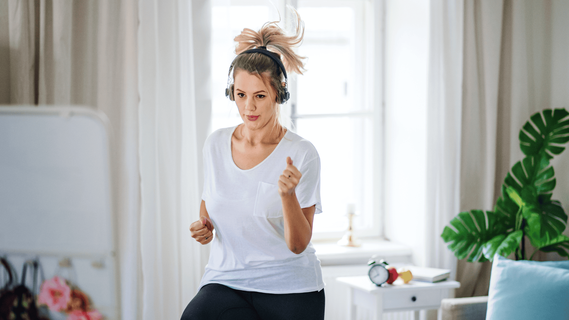 Woman with Headphones Exercising at Home