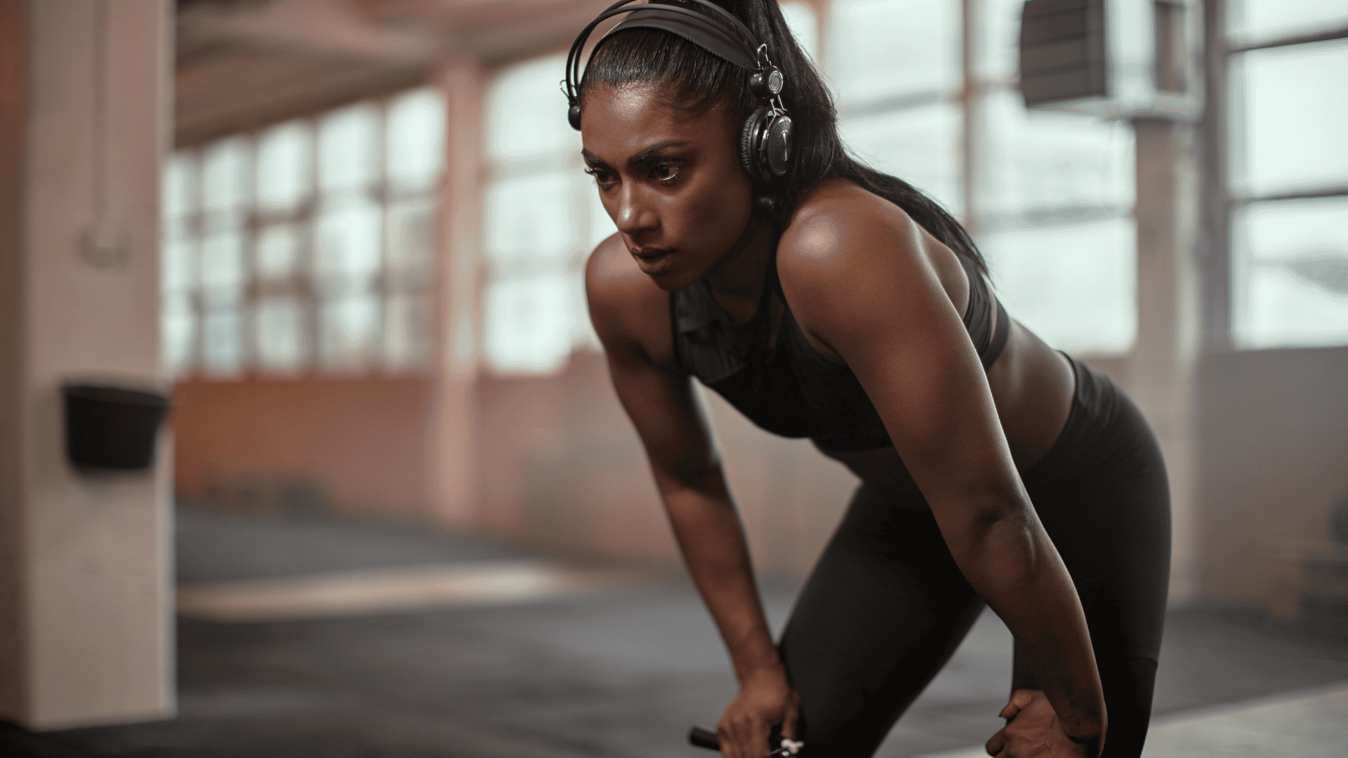 Woman with headphones resting after workout at home