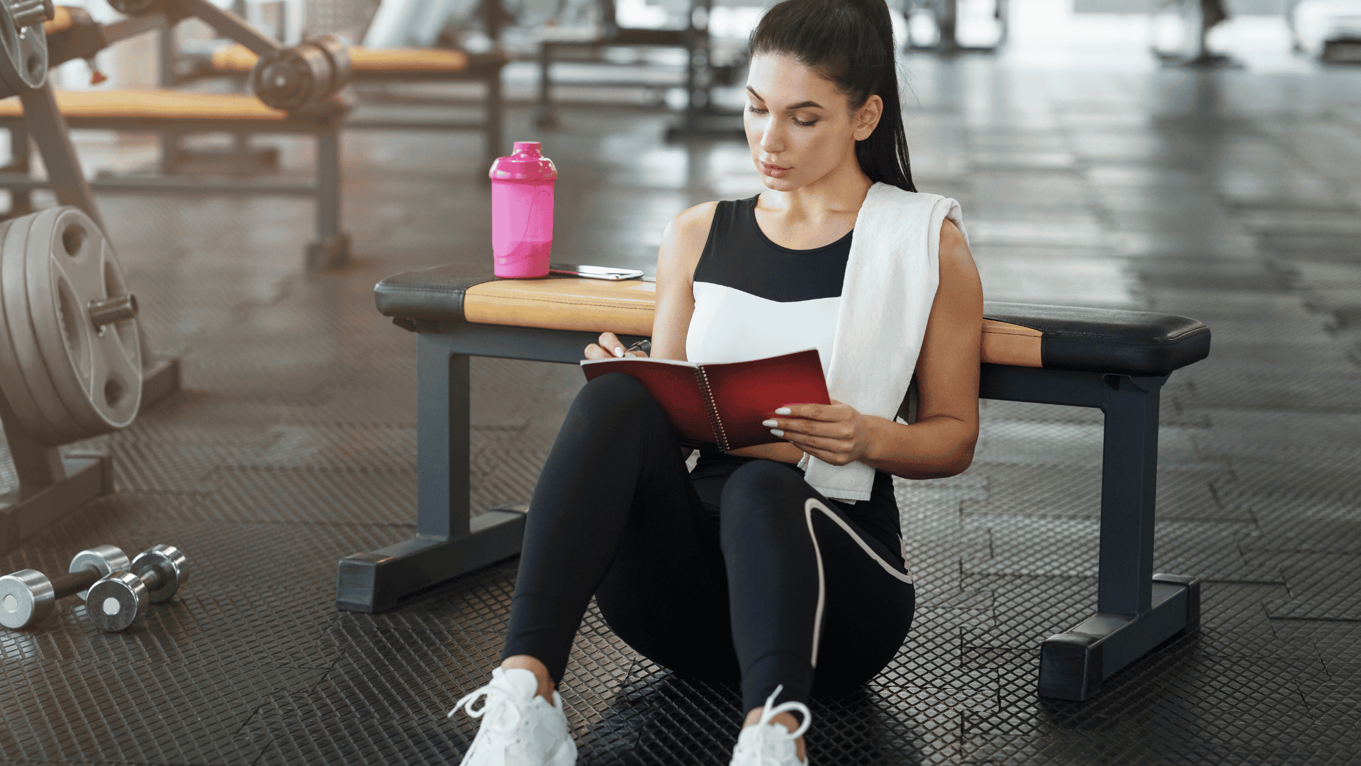 AN Overlay Template - 2025-08-04T154059.850 Attractive woman with notebook planning her workout schedule in sports club