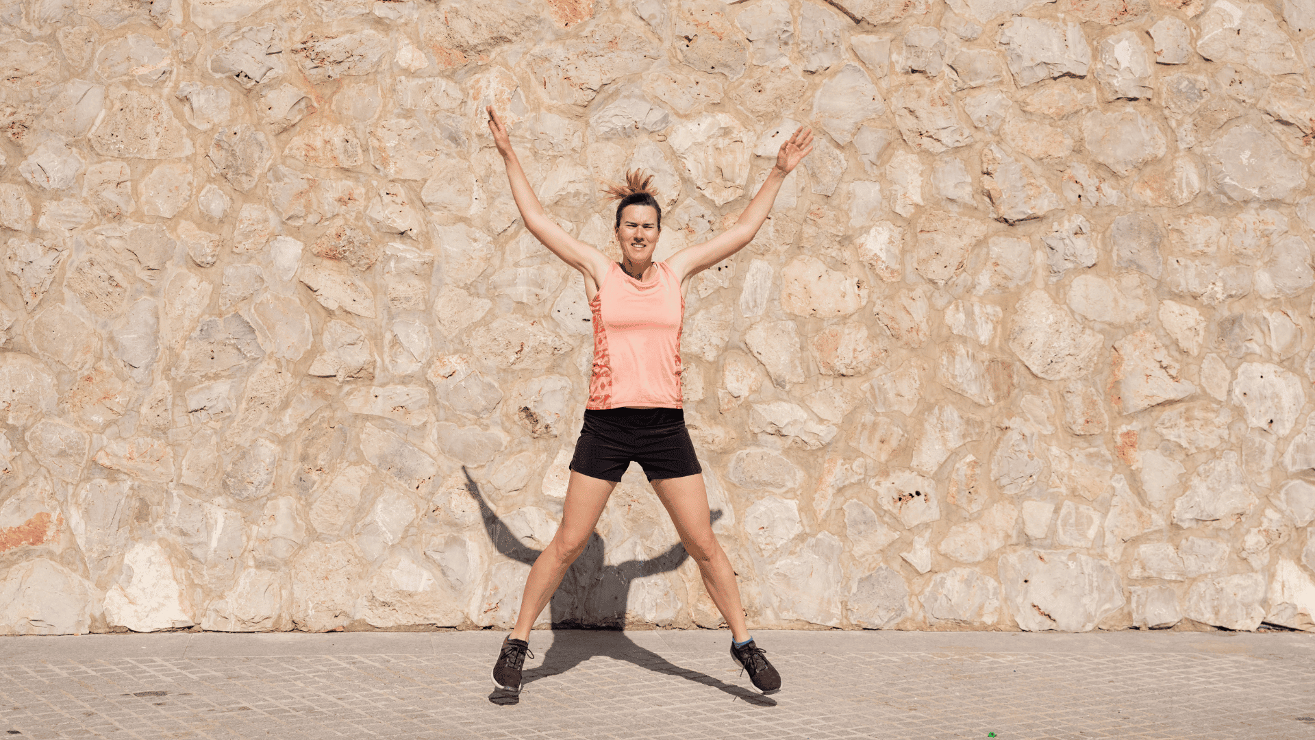 Woman Doing Jumping Jacks Outdoors